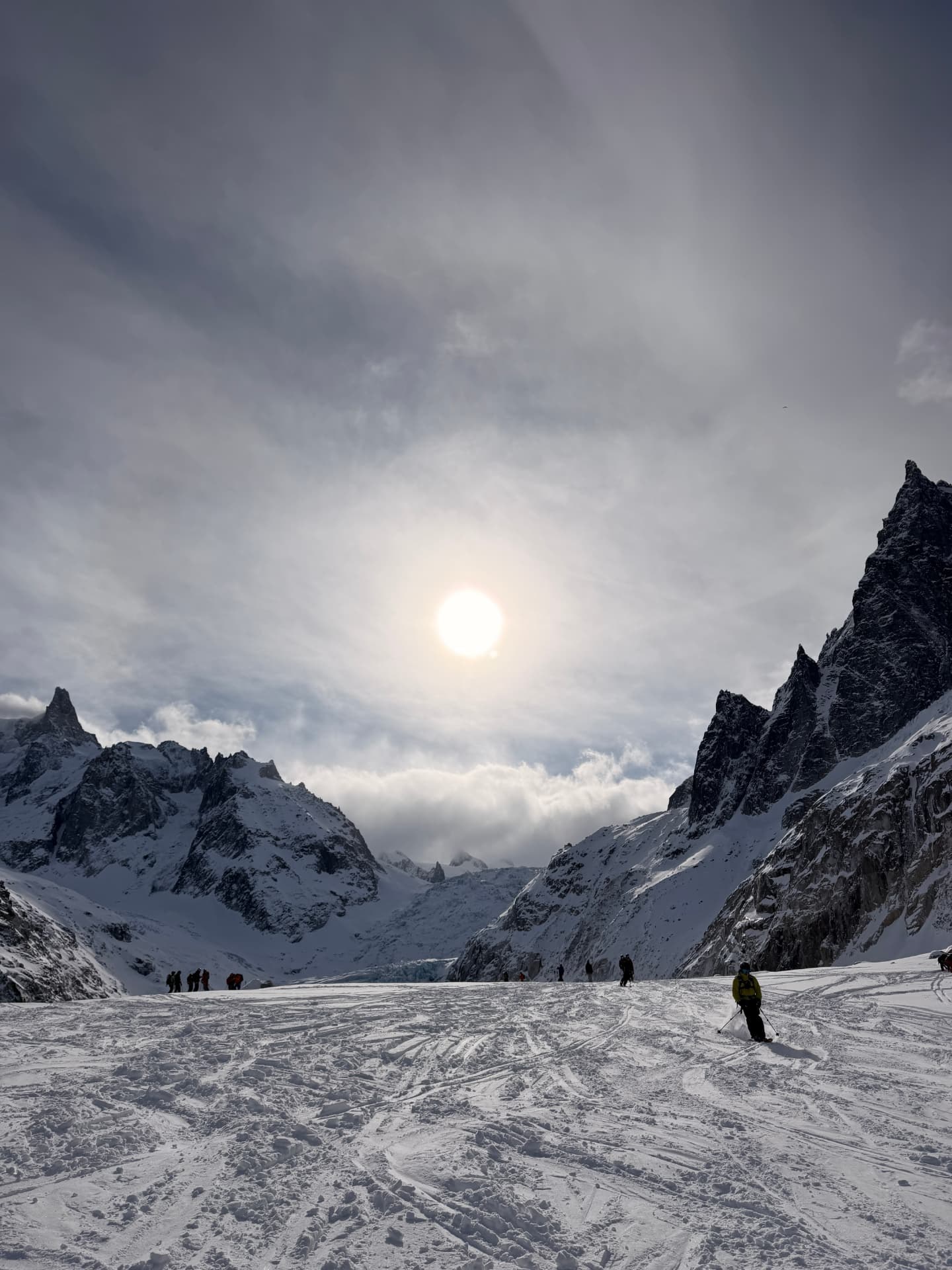 Skiers beneath sunlit peaks in Chamonix